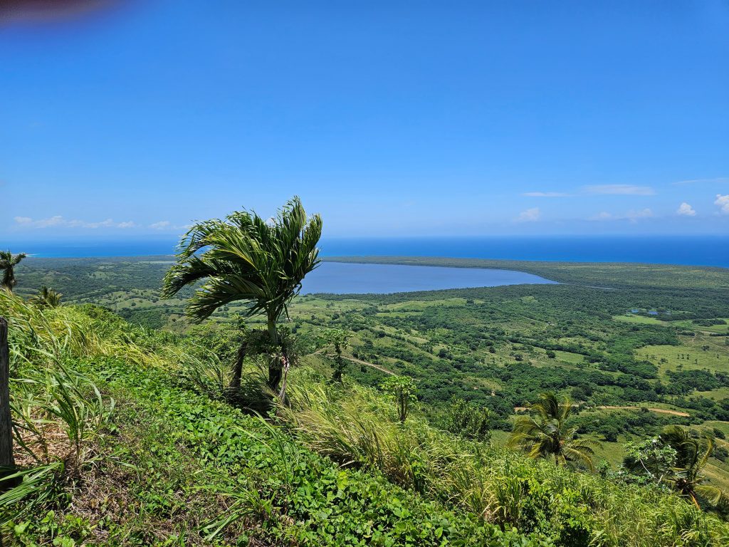 High view of Miches with Playa Esmeralda, Laguna Limón, and lush green countryside beside the serene Caribbean Sea